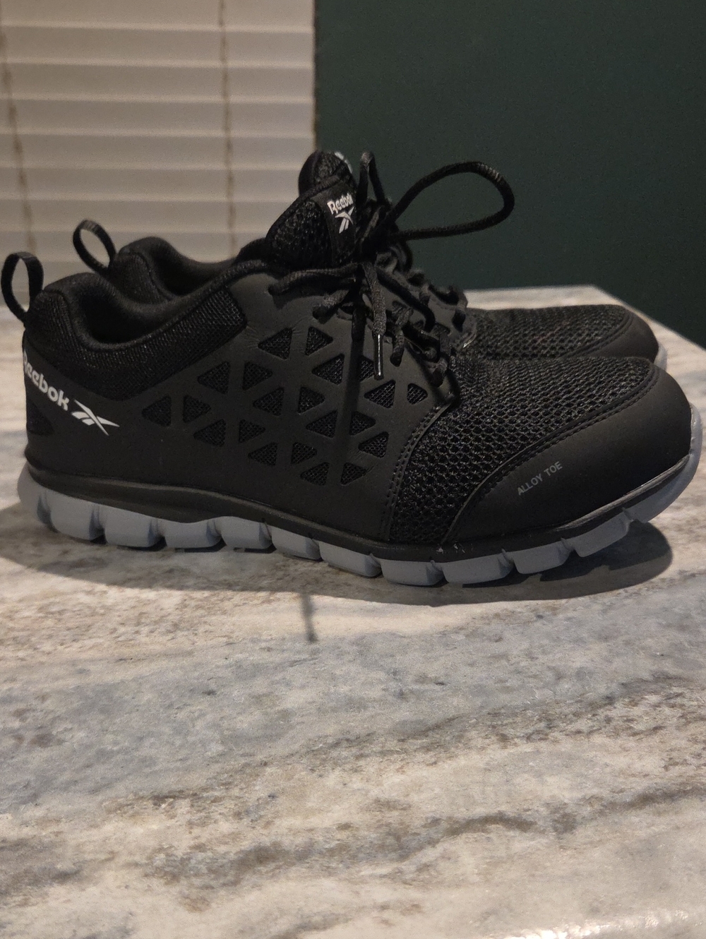 Reebok Sublite Cushion Work RB4041 Alloy Toe Athletic Work Shoes in black.